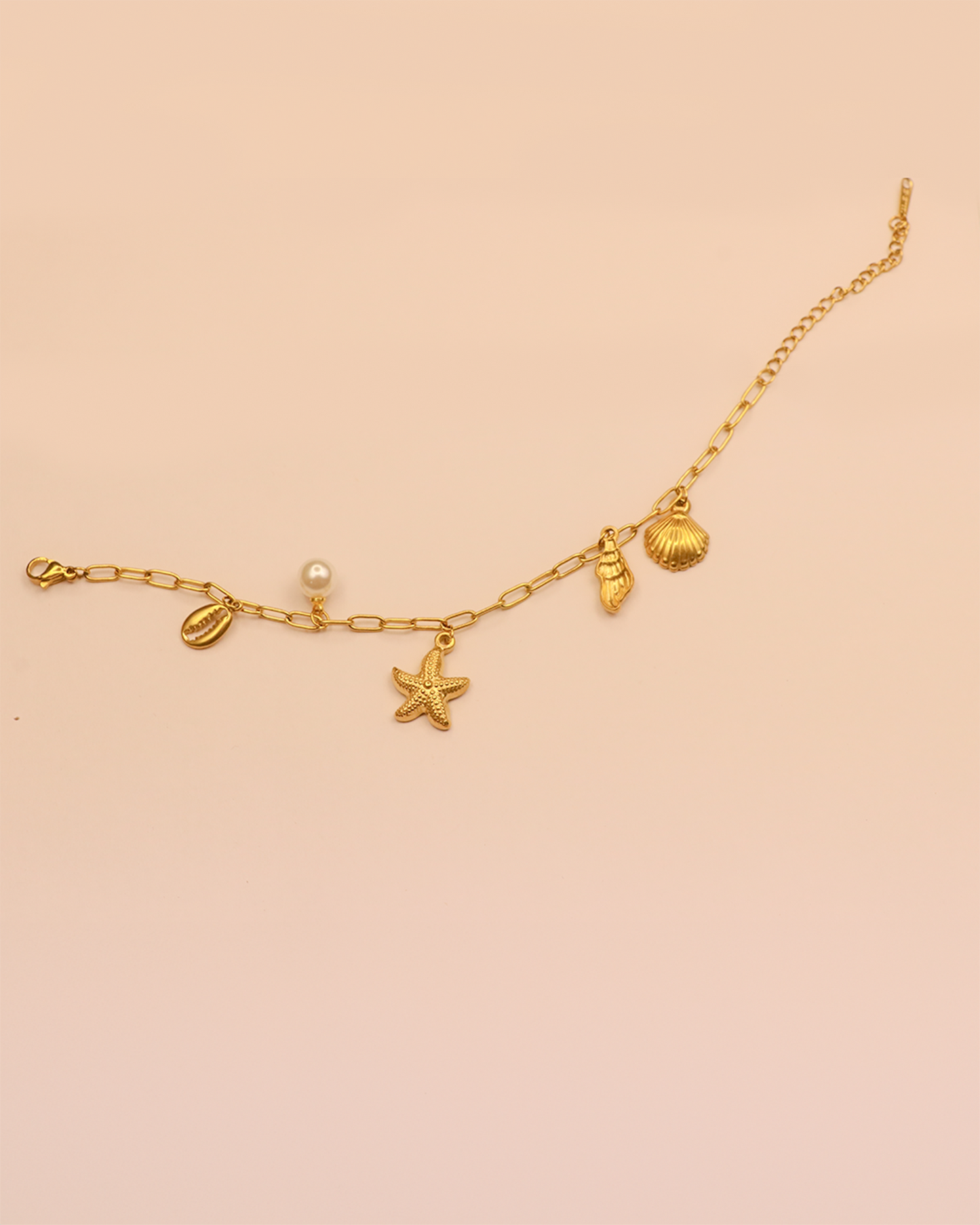 Gold bracelet with starfish, shell, and pearl charms