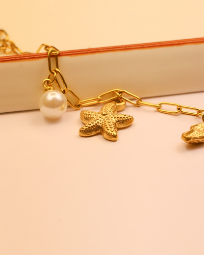 Gold bracelet with starfish and pearl charm 